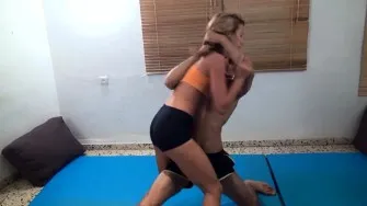 Wrestles her submissive boyfriend indoor
